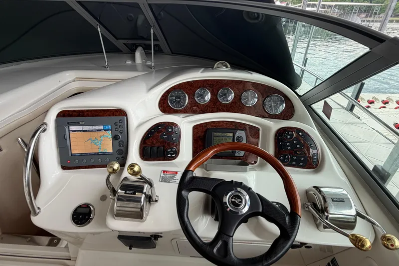 Slide: The Image of Dashboard of a 2007 Sea Ray Sundancer 320 boat with navigation controls and gauges. - 13