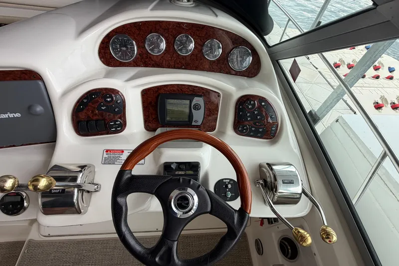 Slide: The Image of Cockpit of 2007 Sea Ray Sundancer 320 with steering wheel and control panel. - 16