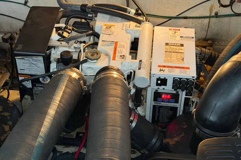 Slide: The Image of Engine compartment of a 2007 Sea Ray Sundancer 320 with Kohler generator and hoses. - 34