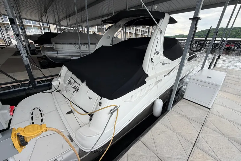 Slide: The Image of 2007 Sea Ray Sundancer 320 docked under a covered marina slip. - 4