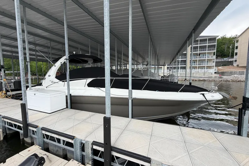 Slide: The Image of 2007 Sea Ray Sundancer 320 docked under covered marina, featuring sleek design and modern amenities. - 5