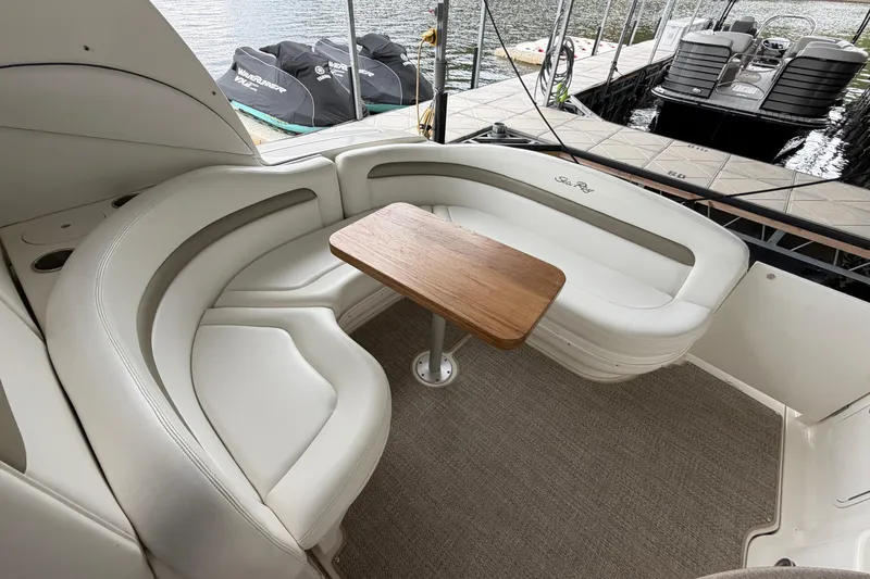 Slide: The Image of Luxurious seating area on a 2007 Sea Ray Sundancer 320 yacht with a wooden table. - 7