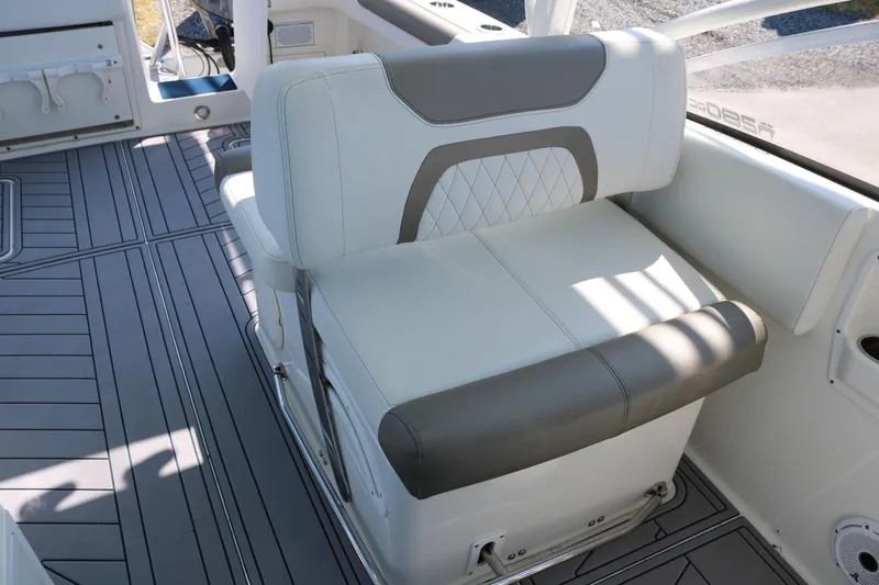 Slide: The Image of 2023 World Cat 280 DC-X boat interior with cushioned seating and sleek flooring design. - 10
