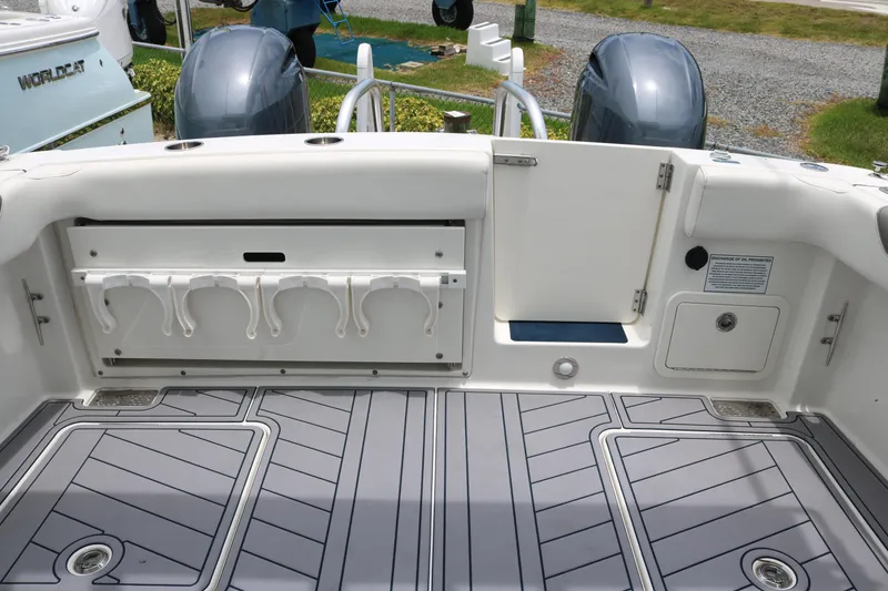 Slide: The Image of 2023 World Cat 280 DC-X boat deck with rod holders and storage compartments. - 14