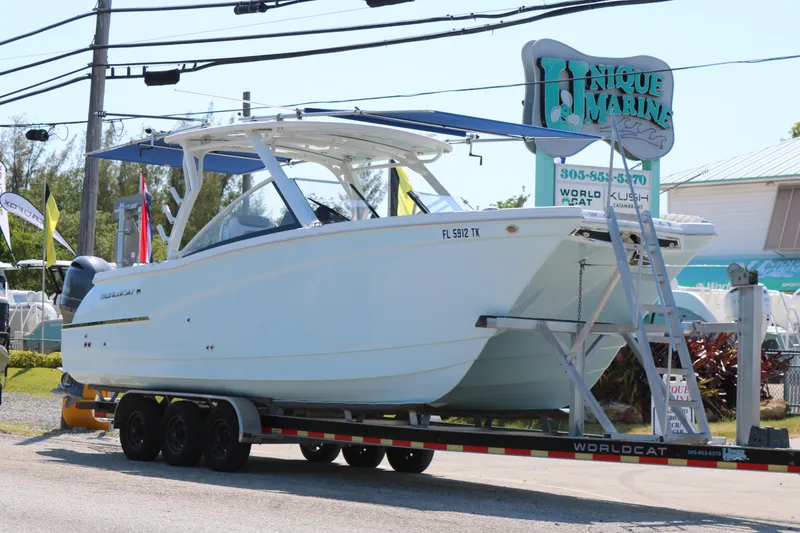 Slide: The Image of 2023 World Cat 280 DC-X boat on trailer at Unique Marine dealership. - 2