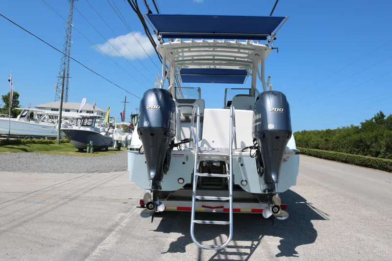 Slide: The Image of 2023 World Cat 280 DC-X boat with twin Yamaha 200 engines, parked outdoors. - 4