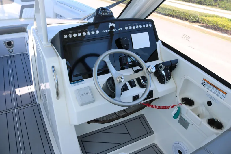 Slide: The Image of Helm of 2023 World Cat 280 DC-X boat with steering wheel and control panel. - 8