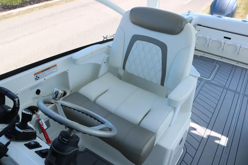 Slide: The Image of Captain's seat of 2023 World Cat 280 DC-X boat, featuring modern controls and sleek design. - 9
