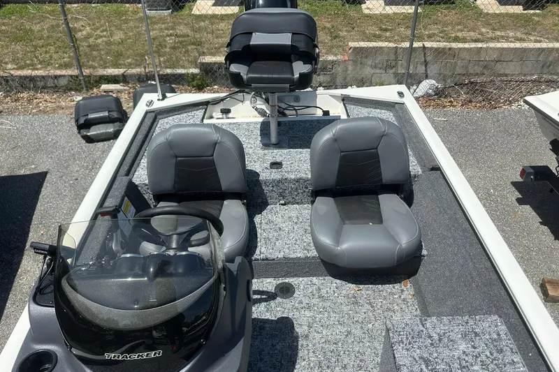 Slide: The Image of 2026 Tracker Pro Team 170 TX boat interior with gray seating and steering console. - 11