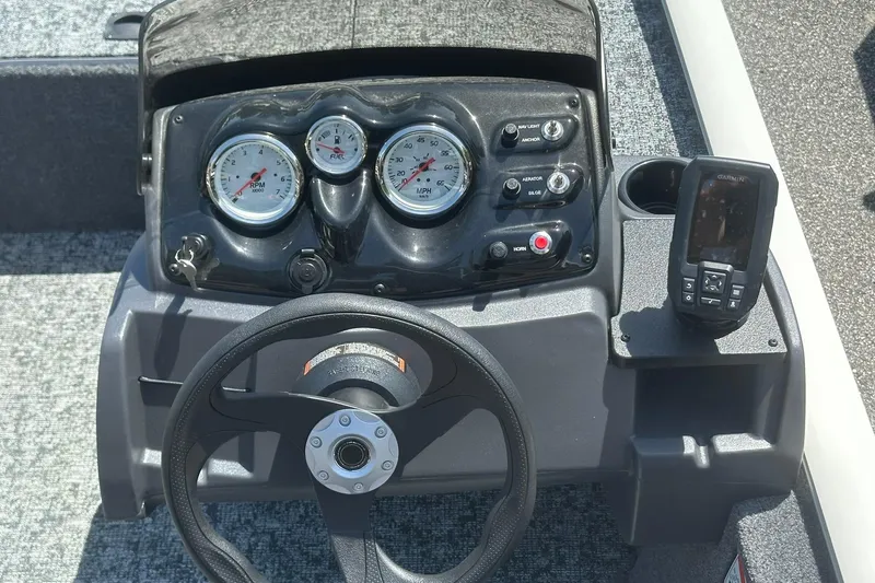 Slide: The Image of 2026 Tracker Pro Team 170 TX boat dashboard with gauges and navigation system. - 12