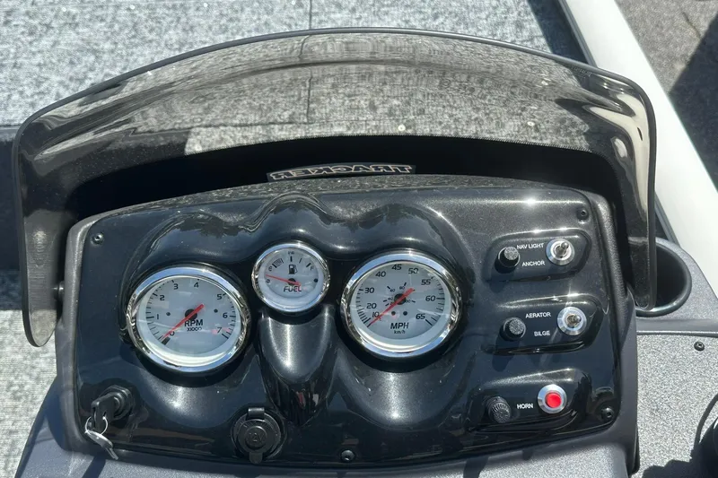Slide: The Image of Dashboard of 2026 Tracker Pro Team 170 TX boat with gauges and controls. - 13