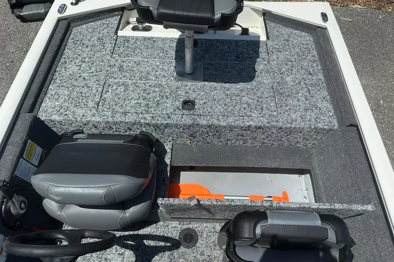 Slide: The Image of 2026 Tracker Pro Team 170 TX boat interior with gray seating and storage compartments. - 14