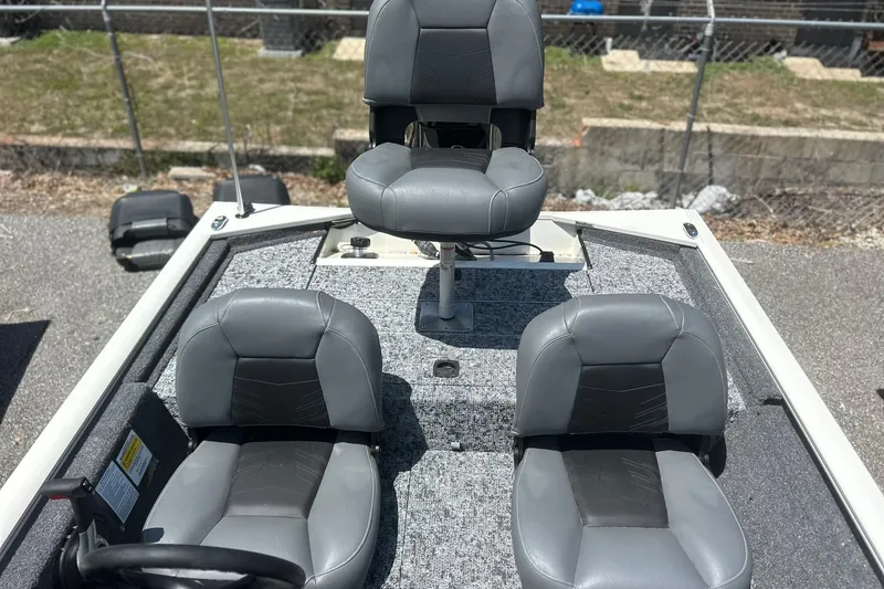 Slide: The Image of 2026 Tracker Pro Team 170 TX boat interior with three gray seats. - 15