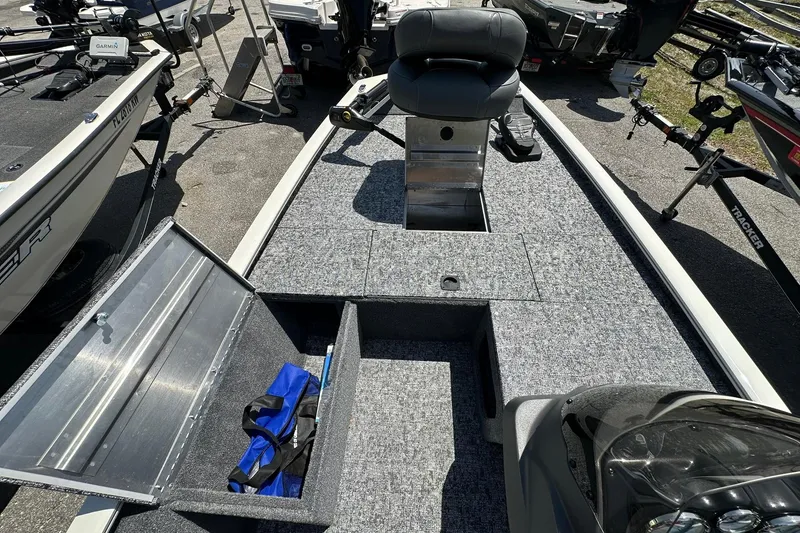 Slide: The Image of 2026 Tracker Pro Team 170 TX boat interior with storage compartments and seating. - 8