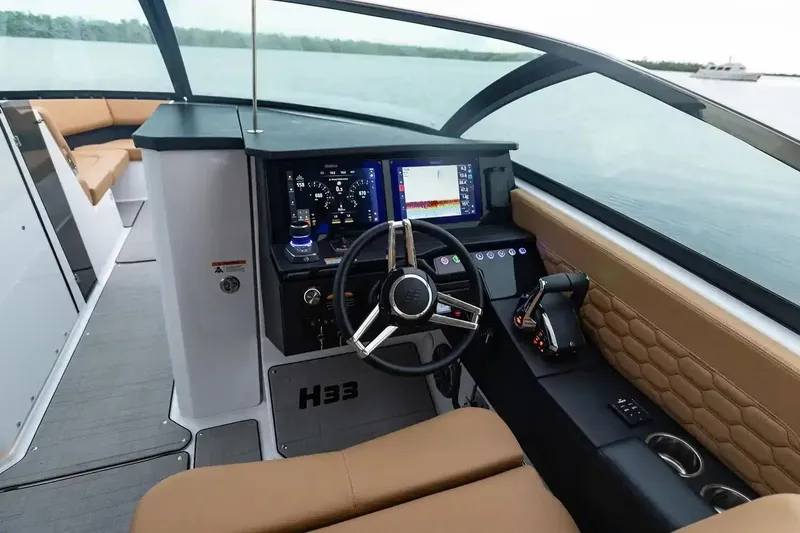 Slide: The Image of Manufacturer Provided Image: 2026 Four Winns H33 OB boat cockpit with modern controls and navigation system. - 3