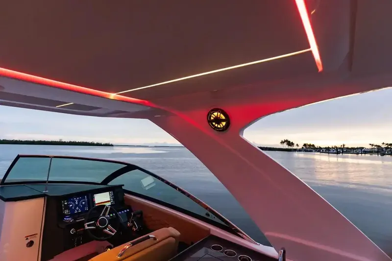 Slide: The Image of Manufacturer Provided Image: Interior view of 2026 Four Winns H33 OB boat with modern lighting and scenic water backdrop. - 4