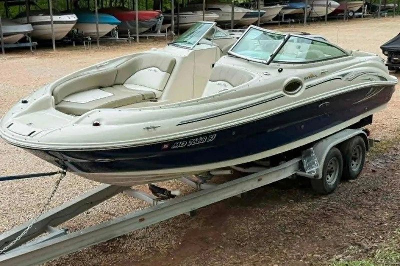 Slide: The Image of 2006 Sea Ray 240 Sundeck boat on trailer, parked in a marina. - 15