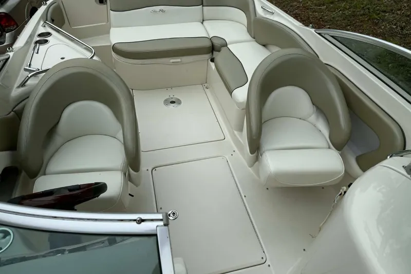 Slide: The Image of Interior of a 2006 Sea Ray 240 Sundeck boat with white seating and cup holders. - 2