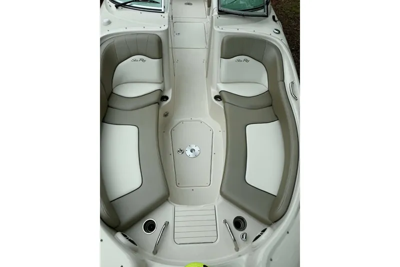 Slide: The Image of 2006 Sea Ray 240 Sundeck interior with beige seating and sleek design. - 3