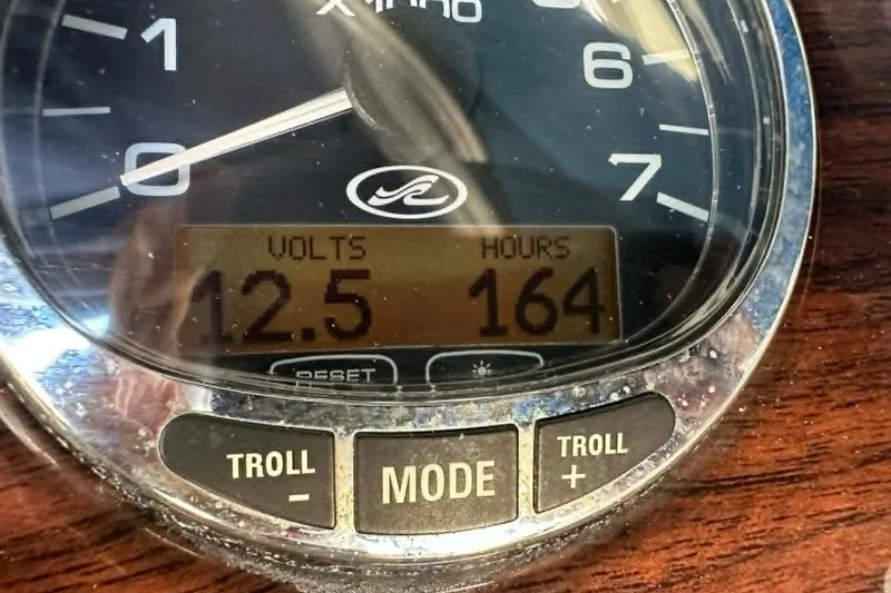 Slide: The Image of Close-up of a 2006 Sea Ray 240 Sundeck gauge showing 12.5 volts and 164 hours. - 4