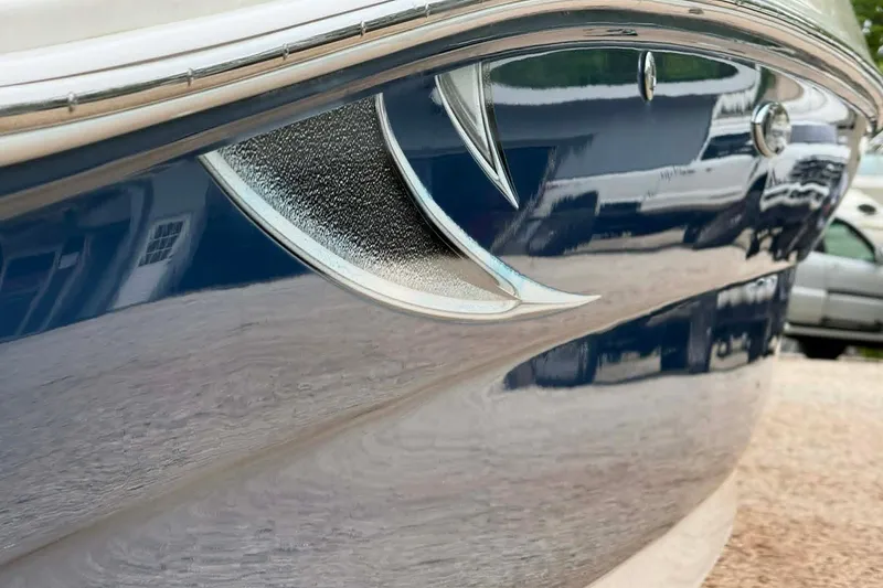 Slide: The Image of Close-up of a 2006 Sea Ray 240 Sundeck boat hull with sleek design details. - 9