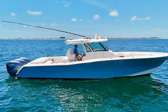 The Image of 2020 Grady-White Canyon 376 boat cruising on open water under clear skies. - 0
