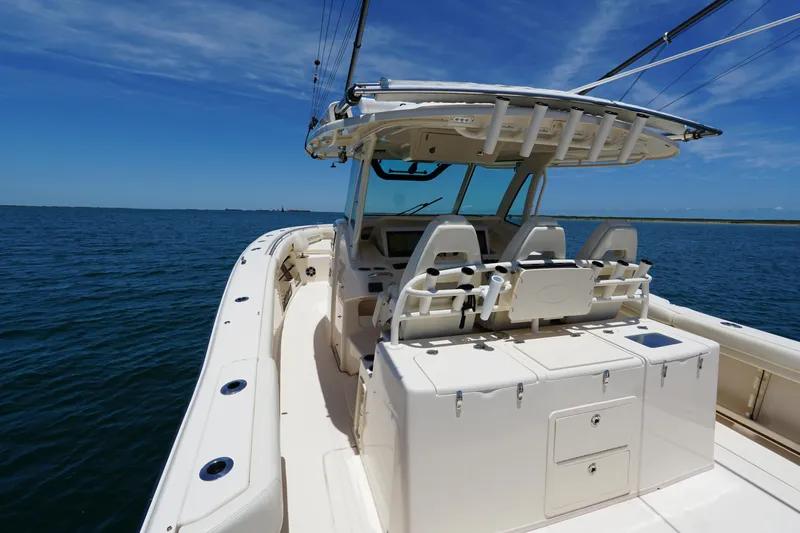 Slide: The Image of 2020 Grady-White Canyon 376 boat on open water under clear blue sky. - 10