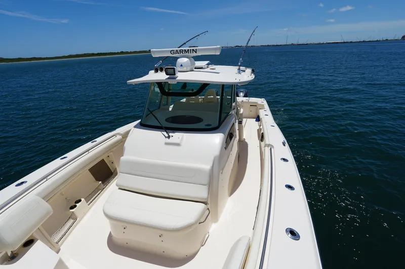Slide: The Image of 2020 Grady-White Canyon 376 boat on open water, featuring Garmin equipment. - 12
