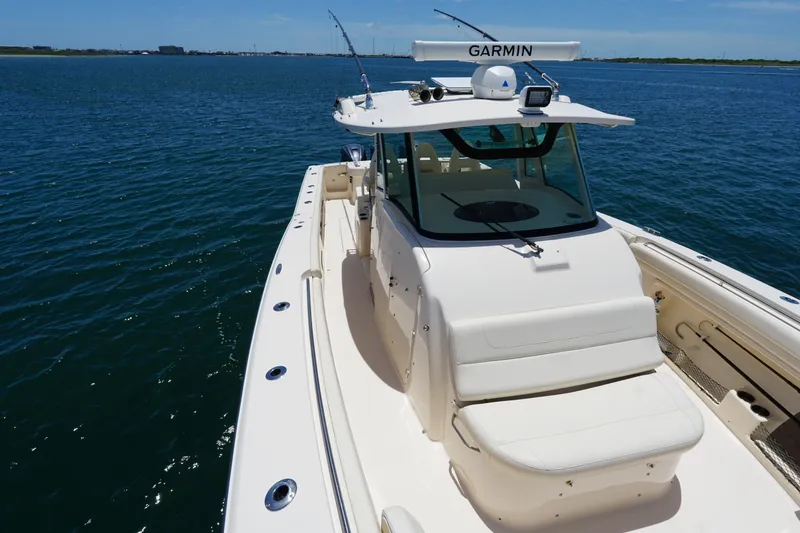 Slide: The Image of 2020 Grady-White Canyon 376 boat on open water, featuring Garmin equipment. - 13