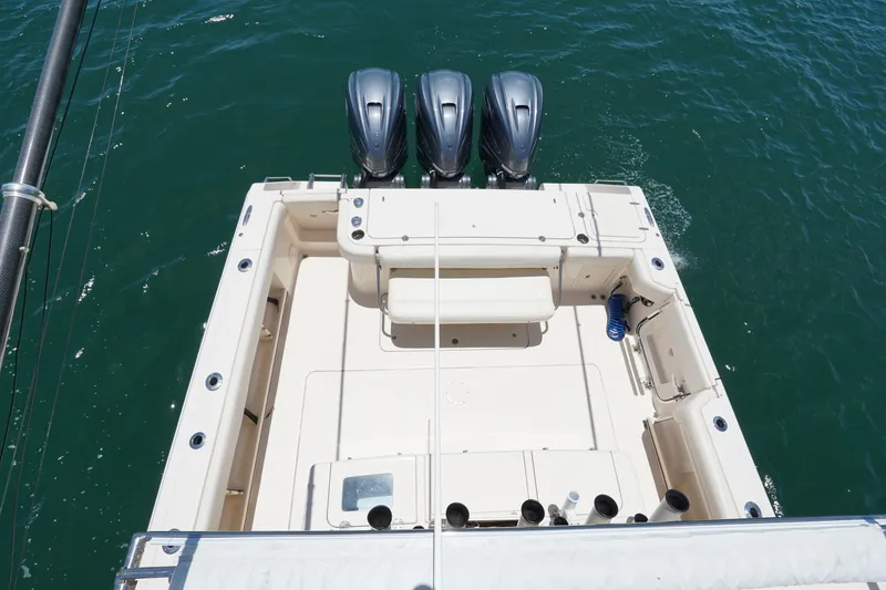 Slide: The Image of 2020 Grady-White Canyon 376 boat with triple engines on open water. - 15