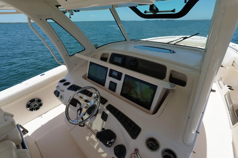 Slide: The Image of 2020 Grady-White Canyon 376 helm with advanced navigation systems on open water. - 17