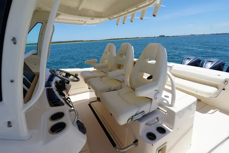 Slide: The Image of 2020 Grady-White Canyon 376 boat interior with helm seats and ocean view. - 18