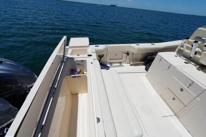 Slide: The Image of 2020 Grady-White Canyon 376 boat deck with storage and seating, on calm blue water. - 20
