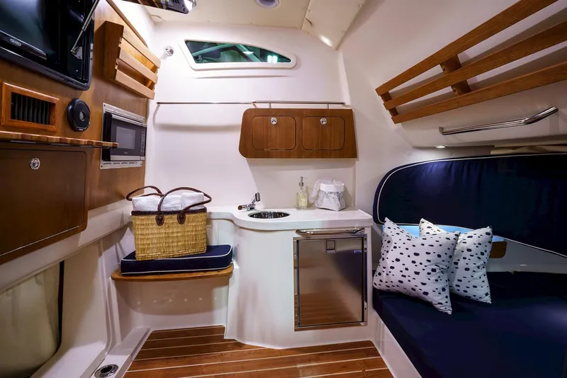 Slide: The Image of Manufacturer Provided Image: Interior cabin of 2020 Grady-White Canyon 376 boat with kitchenette and seating area. - 22