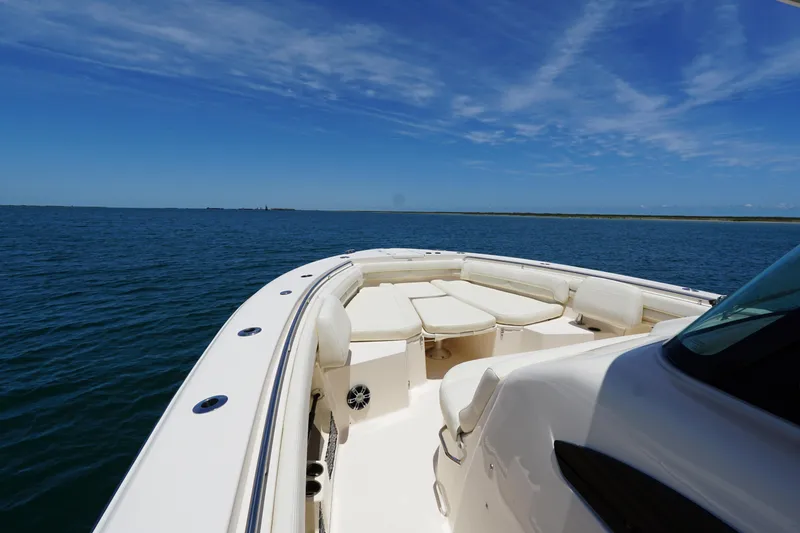 Slide: The Image of 2020 Grady-White Canyon 376 boat on open water under clear blue sky. - 5