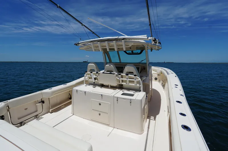Slide: The Image of 2020 Grady-White Canyon 376 boat on open water under clear blue sky. - 9