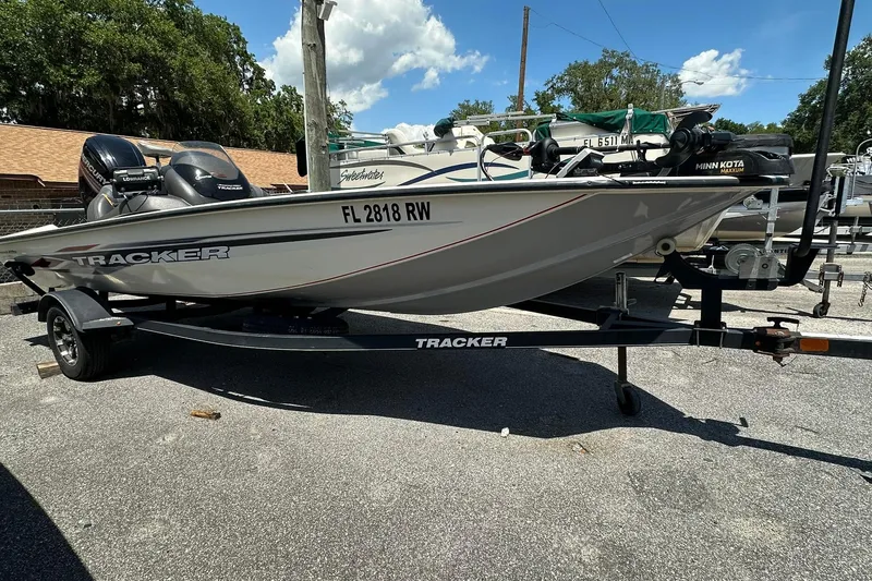 The Image of 2019 Tracker Pro Team 175 TXW Tournament Edition boat on trailer, parked outdoors. - 1