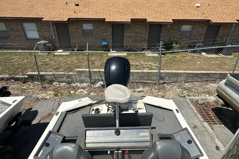 Slide: The Image of 2019 Tracker Pro Team 175 TXW Tournament Edition boat parked near a brick building. - 14