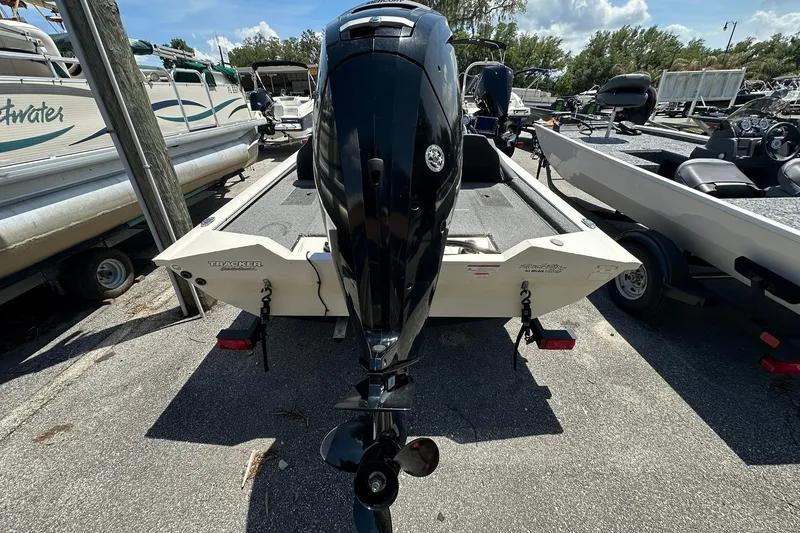 Slide: The Image of 2019 Tracker Pro Team 175 TXW Tournament Edition boat with outboard motor, parked on trailer. - 19