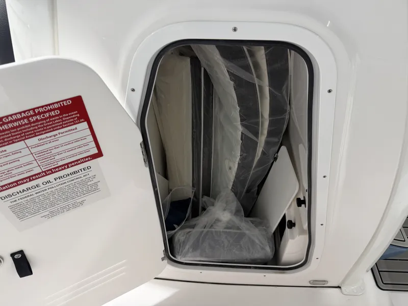 Slide: The Image of Storage compartment of Tidewater 232 CC Adventure 2026 with safety warning. - 27