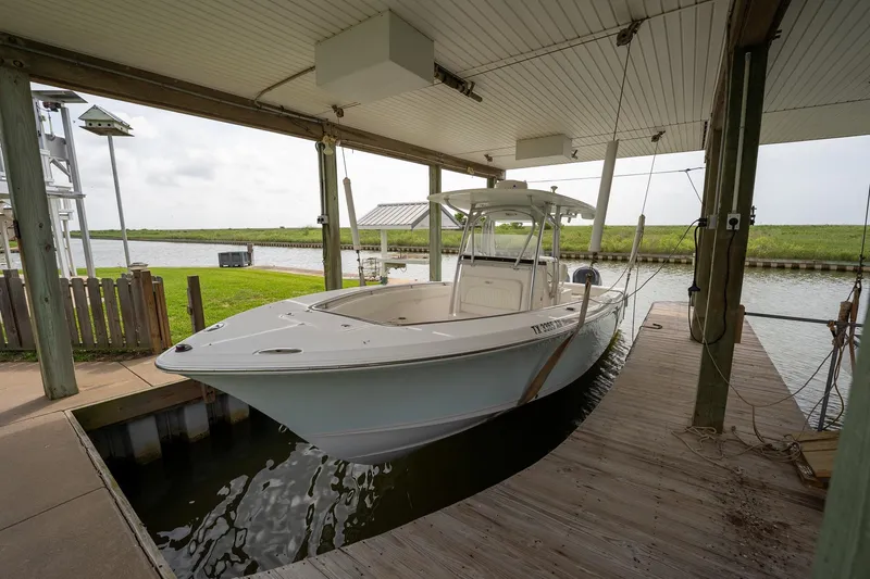 Slide: The Image of 2007 Sea Hunt Triton 290 boat docked under covered marina. - 1