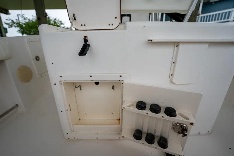 Slide: The Image of 2007 Sea Hunt Triton 290 boat interior with storage compartment and rod holders. - 18