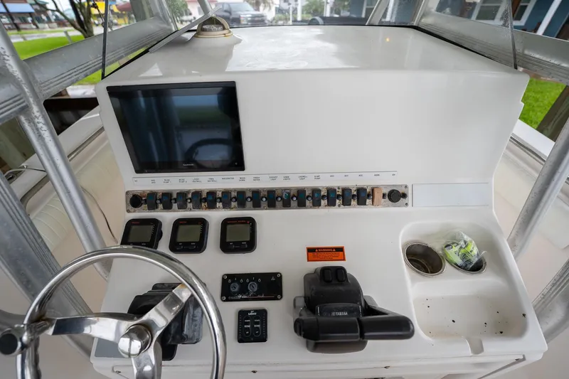 Slide: The Image of 2007 Sea Hunt Triton 290 boat dashboard with steering wheel and control panel. - 22