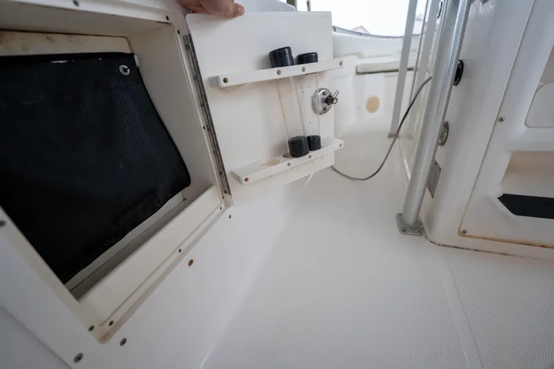 Slide: The Image of 2007 Sea Hunt Triton 290 boat interior with storage compartment and rod holders. - 25