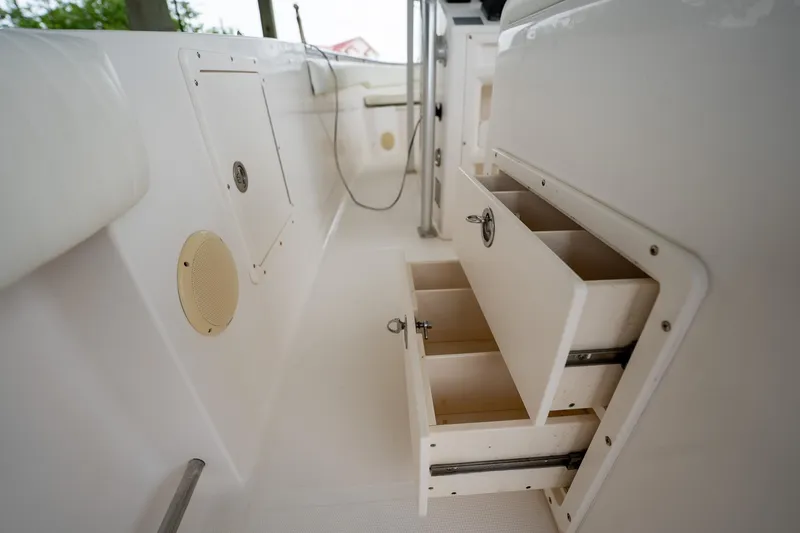 Slide: The Image of 2007 Sea Hunt Triton 290 boat interior with open storage compartments. - 26