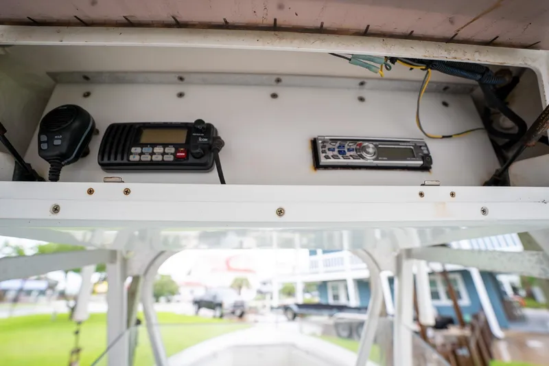 Slide: The Image of 2007 Sea Hunt Triton 290 boat dashboard with radio and communication equipment. - 28