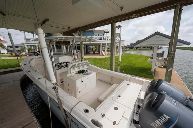 Slide: The Image of 2007 Sea Hunt Triton 290 boat docked, featuring dual Yamaha engines, in a waterfront setting. - 3