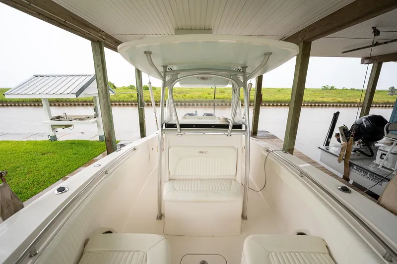 Slide: The Image of 2007 Sea Hunt Triton 290 boat docked, featuring spacious seating and a covered helm. - 32