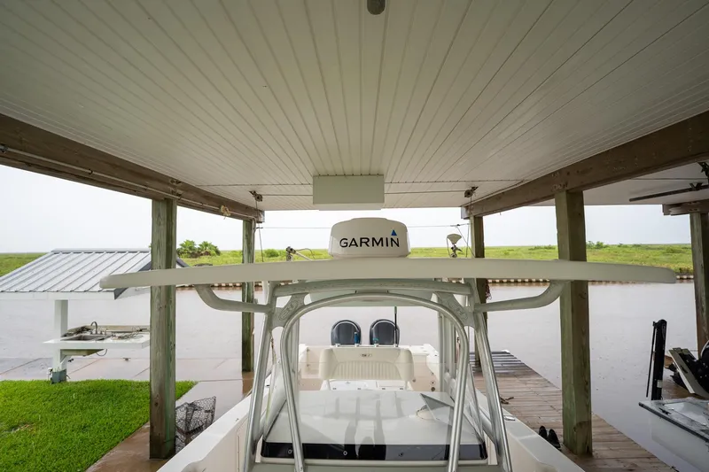 Slide: The Image of 2007 Sea Hunt Triton 290 boat docked under a covered structure with Garmin equipment. - 33