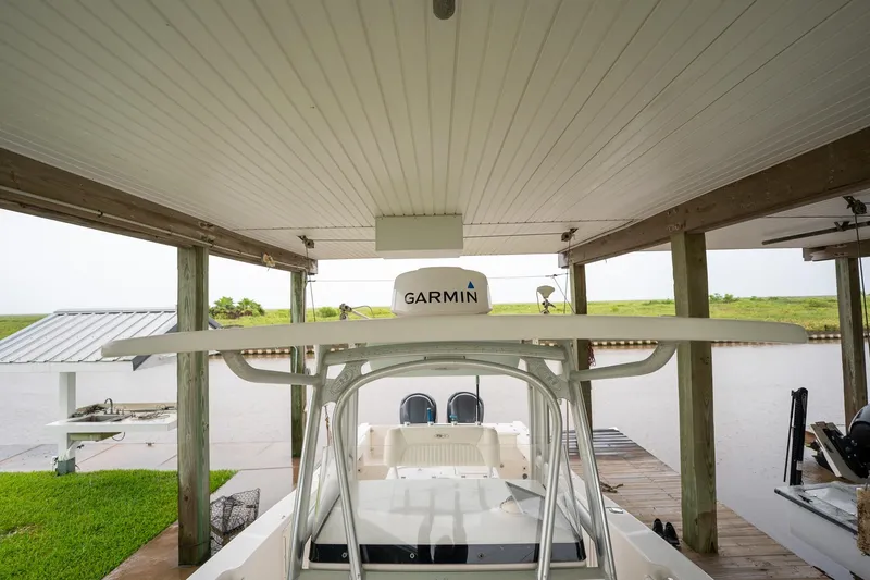 Slide: The Image of 2007 Sea Hunt Triton 290 boat docked under a covered structure with Garmin equipment. - 34